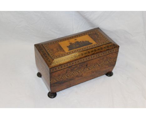 A 19th Century Tunbridgeware tea caddy of sarcophagus form, the rising lid decorated with Windsor Castle and opening to revea