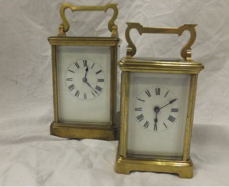 A circa 1900 brass cased carriage clock, the white enamel dial with Roman numerals, together with another smaller similar (2)