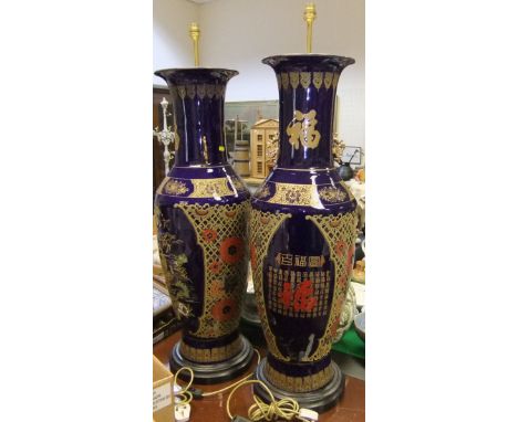 A pair of mid 20th Century Chinese blue glazed gilt and enamel decorated floor vases, converted to lamps