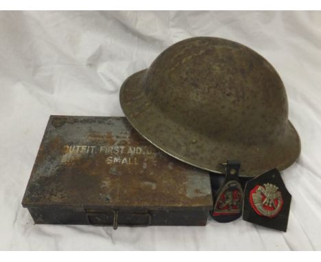 A box containing a collection of First World War memorabilia to include regimental badge, pith helmet, tin helmet, etc