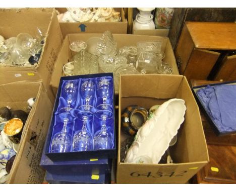 A boxed set of six small glass wines decorated with hunting scenes, two sets of three cut glass hock glasses, a set of Crista
