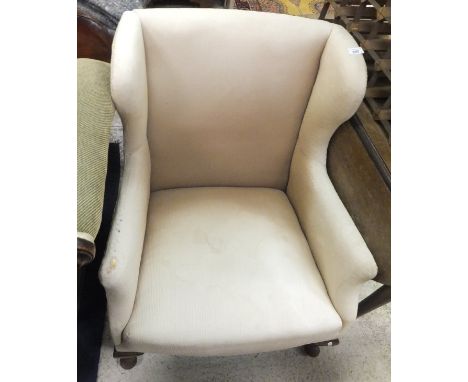 A button back tub chair with cream ground patterned upholstery, an early 20th Century wing back armchair raised on cabriole f