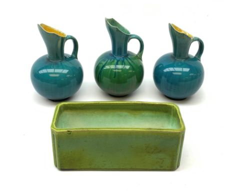 Three Linthorpe pottery jugs, two with turquoise ground, the other with merging turquoise and green, all impressed beneath 12