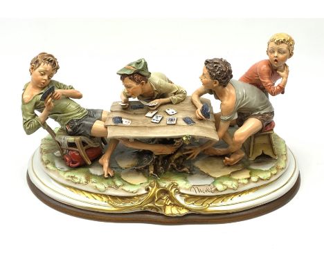 Large Capodimonte figure group 'The Card Cheat', modelled as four card players, signed Merli, raised on a wooden base L56cm  