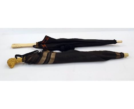 Vintage umbrella with a bakelite head formed as a dog and a bone-handled umbrella with carved daisies, the centre of the dais