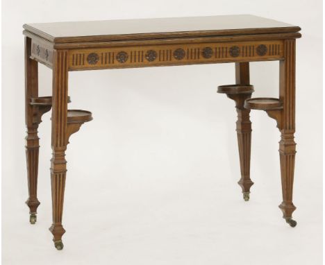 A Victorian walnut fold-over card table,the top with a circular baize surface, four counter wells, plated trays and screw thr