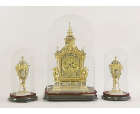 A French gilt metal and champlevé clock garniture, late 19th century, the clock with an eight-day bell strike movement within