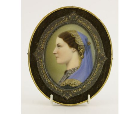 A Continental porcelain plaque,19th century, a portrait of a young woman wearing a blue head scarf, with fine gilt detailing,