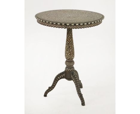 A hoshiarpur hardwood and inlaid occasional table, 19th century, the circular top with scrolling foliate ivory inlay, on turn