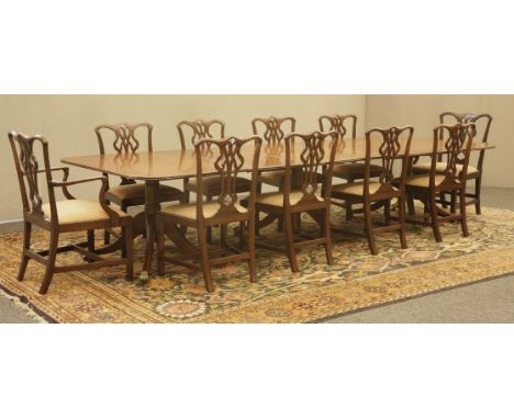 A large George III-style mahogany triple-pillar dining table, the figured top over each pillar, with a turned baluster on fou