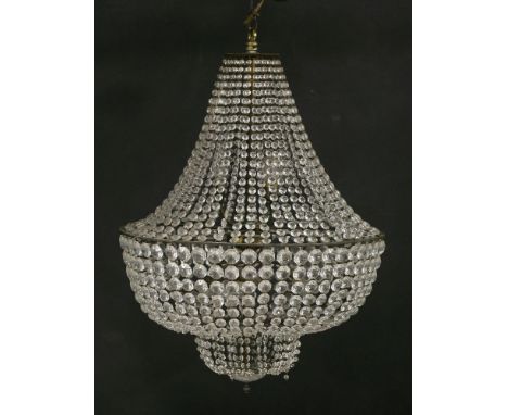 A large basket chandelier,with glass drops and seven lights,80cm high,together with four matching wall lights,with cast detai