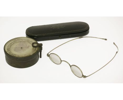 A pair of Regency white metal spectacles,test silver, in a papier mâché case, anda brass pocket barometer,by J Hicks, London,