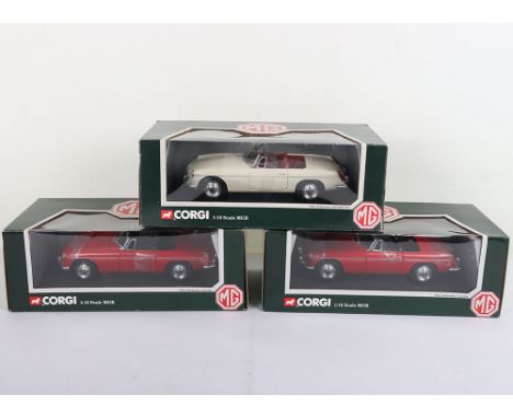 Three Corgi  1:18 Scale 1963 MGB Roadsters, 95104 old English white and 2 x 95103 Tartan red,   all in mint boxed condition. 