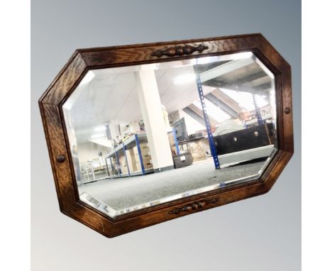 An Edwardian oak framed octagonal mirror 
