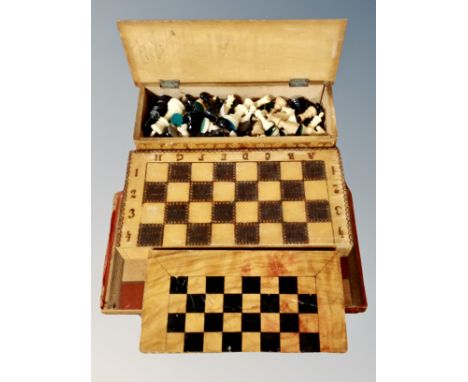 A box of chess pieces, folding chess boards and checkers pieces 