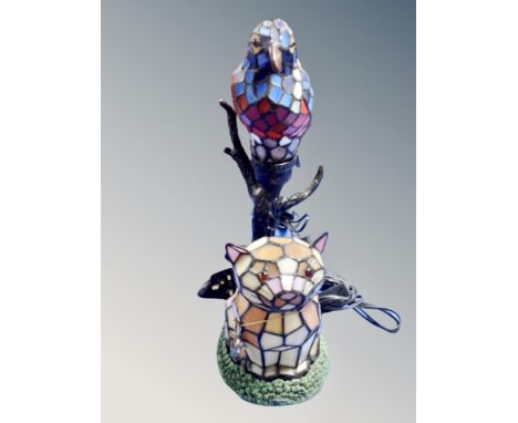 A contemporary leaded glass table lamp in the form of a parrot on branch together with a further cat lamp 