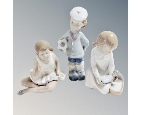 A Lladro figure Soccer Player 4967, together with two Nao figures of a ballerina and a girl with a doll. 