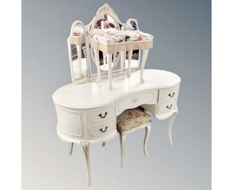 A kidney shaped dressing table with triple mirror and stool together with further dressing table stool 