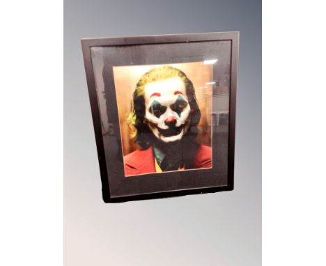 A colour print of Joaquin Phoenix as The Joker, in frame