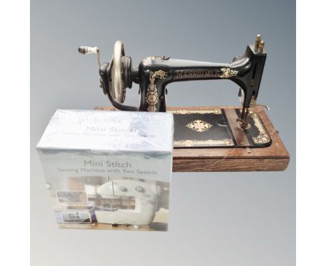 A vintage Harris no. 5 manual sewing machine, together with a Mini Stitch 2-speed sewing machine, boxed and sealed. 