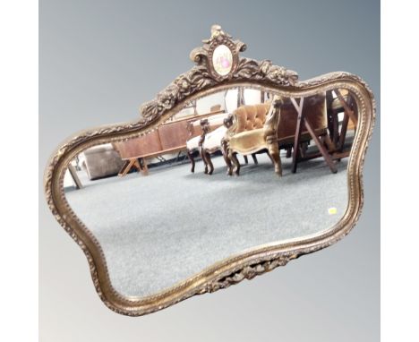 A French style gilt framed mirror with inset porcelain panel 