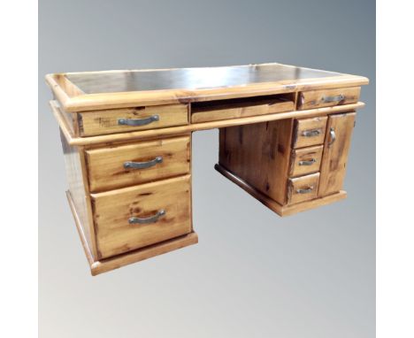 A plantation pine twin pedestal desk fitted with drawers, slide and leather inset panel 