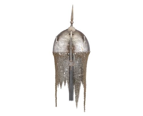 ‡ A PERSIAN HELMET (KULAH-KHUD), QAJAR, LATE 19TH CENTURY with etched hemispherical skull decorated with cartouches, calligra