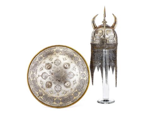 ‡ A PERSIAN HELMET (KULAH-KHUD) AND SHIELD (DHAL), QAJAR, SECOND HALF OF THE 19TH CENTURY of burnished iron, the first with h