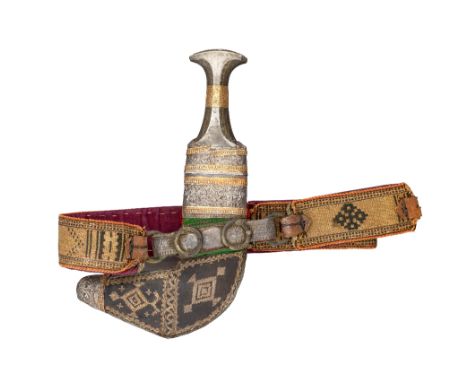 ‡ AN ARAB DAGGER (JAMBIYA), EARLY 20TH CENTURY with curved medially-ridged double-edged blade, horn hilt mounted with silver 