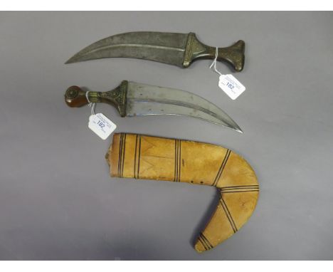TWO ARAB DAGGERS (JAMBIYA), LATE 19TH/EARLY 20TH CENTURY each with broad curved blade formed with a medial ridge on each face