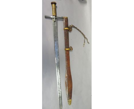 A SUDANESE SWORD (KASKARA), LATE 19TH CENTURY with broad double-edged blade cut with an inscription within a long fuller on e