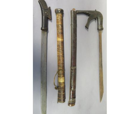 TWO MORO SWORDS (KLEWANG), LATE 19TH CENTURY the first with single-edged blade with a triangular point, finely carved angular