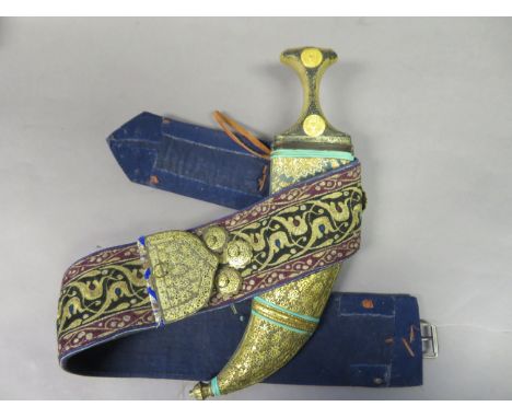 ‡ AN ARAB DAGGER (JAMBIYA), EARLY 20TH CENTURY with curved medially ridged double-edged blade, with silver-studded horn hilt 