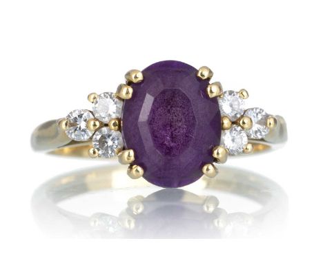 AMETHYST AND DIAMOND RING, the oval amethyst flanked by six small diamonds, in eighteen carat gold, size K 1/2Qty: 3.9g