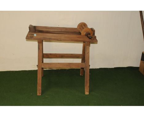 An antique butter table and roller, simple pine construction trestle supporting tray with sides and rolling tool (3) 