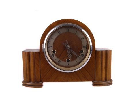 An Art Deco walnut mantle clock,  the silvered chapter ring signed 'Enfield', the domed centre supported by block pillars, 23