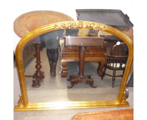 An arched top mirror,  the gilt frame with rose and swag detail, 105cm wide, together with a wrought iron fireguard (2) 