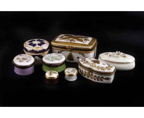 A collection of porcelain and enamel patch boxes,  19th century and later (8) 