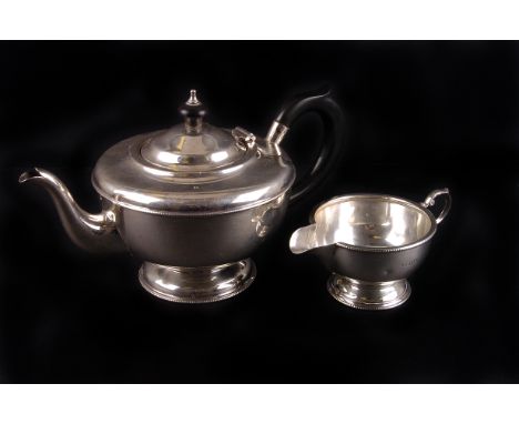 A George V silver circular teapot by Marson & Jones,  Birmingham 1932, with ebonised hoop handle and finial, together with ma