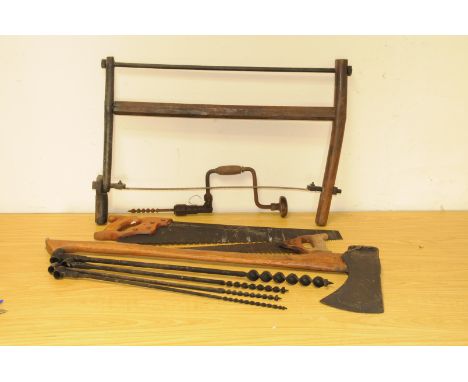 A group of wood and tree related vintage tools, including a good felling axe, an antique frame saw, wood borers, a hand drill