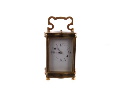 A late 19th century brass repeater carriage clock, with white enamel dial and black Arabic numerals, striking on a coil, with
