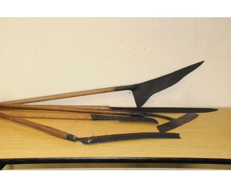 A group of antique and vintage long handled cutting tools, including what it to believed to be a Geordie Giz, a Devon cleaver