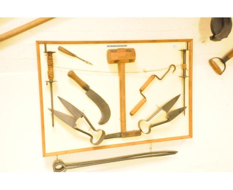 A collection antique and vintage thatcher's tools, mounted on a board, having sheers, a mallet and other utensils including f