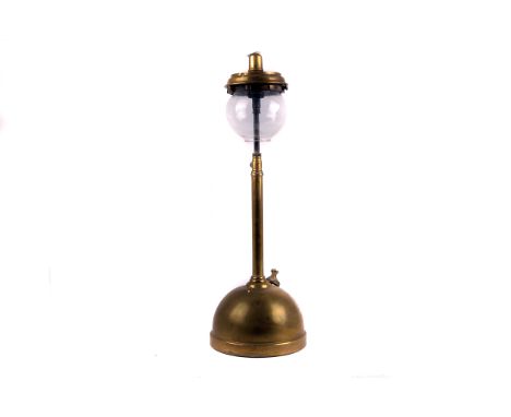A 1920s Tilley brass table lamp,  the domed reservoir with push-button pump, to a plain column, spherical glass shade above, 