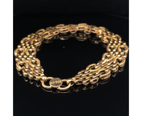 A HEAVY, FANCY GATE LINK BRACELET. THE CLASP STAMPED INDISTINCTLY. ASSESSED AS 18ct GOLD. WIDTH 1.4cms. LENGTH 22cms. WEIGHT 