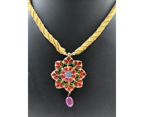 AN INDIAN KUNDAN VINTAGE POLKI PENDANT. THE FRONT SET WITH VARIOUS GEMSTONES TO INCLUDE RUBY, DIAMOND, EMERALD, SAPPHIRE, COR