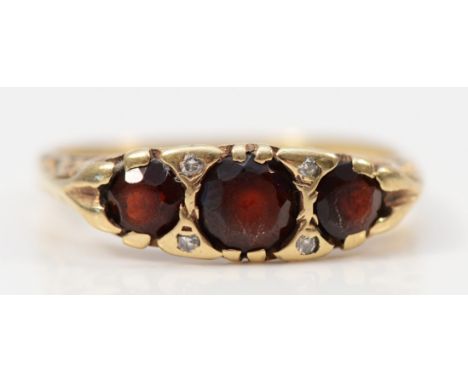 A 9ct gold vintage garnet and diamond ring with patterned gallery, O, 2.6g 
