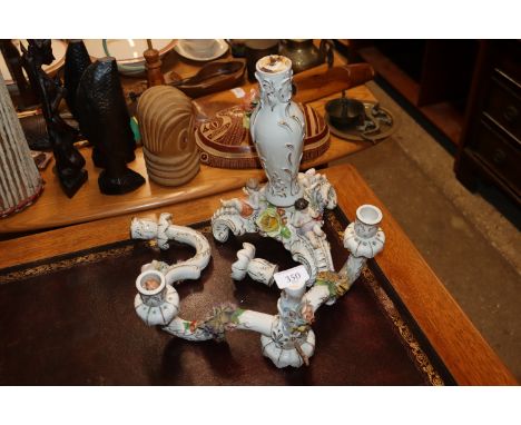 A Meissen style floral encrusted and cherub decorated porcelain candelabra AF