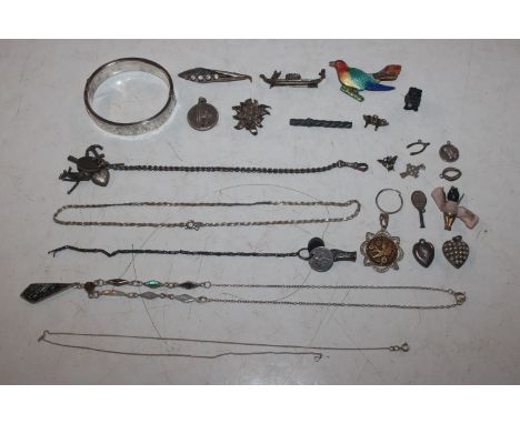 A box of silver and white metal items to include silver snap bangle, silver brooches, charms etc.