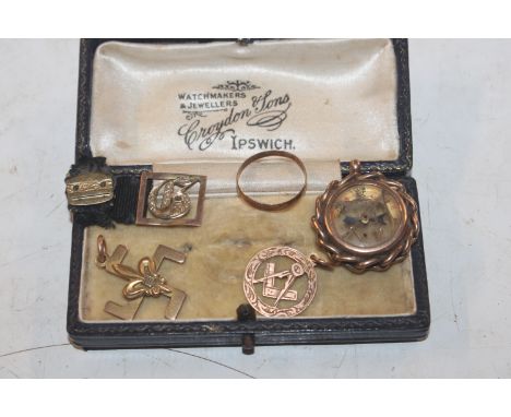 Two 9ct gold pendants, 4gms total weight; a 9ct gold mounted compass 7.5gms total weight; a 9ct gold buckle and a yellow meta